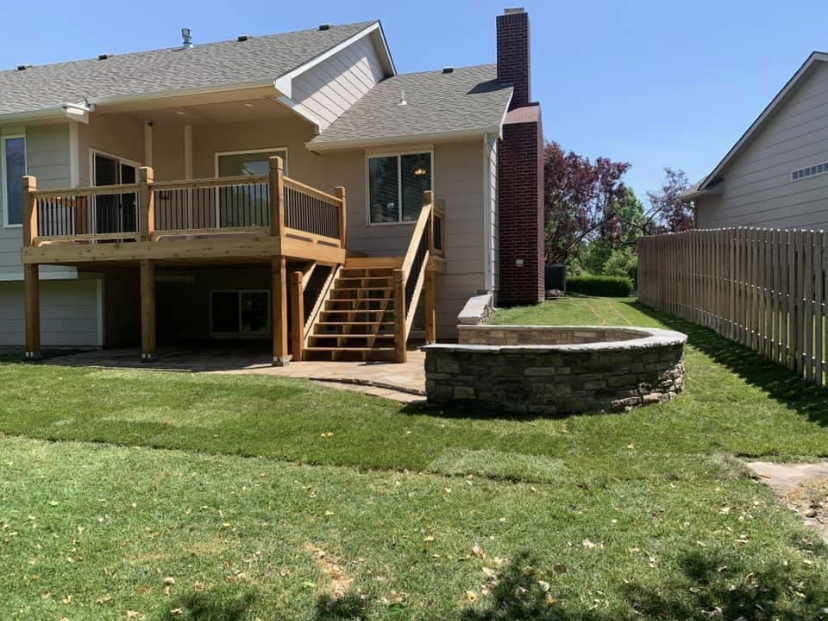Elevated deck with stone fire pit surround
