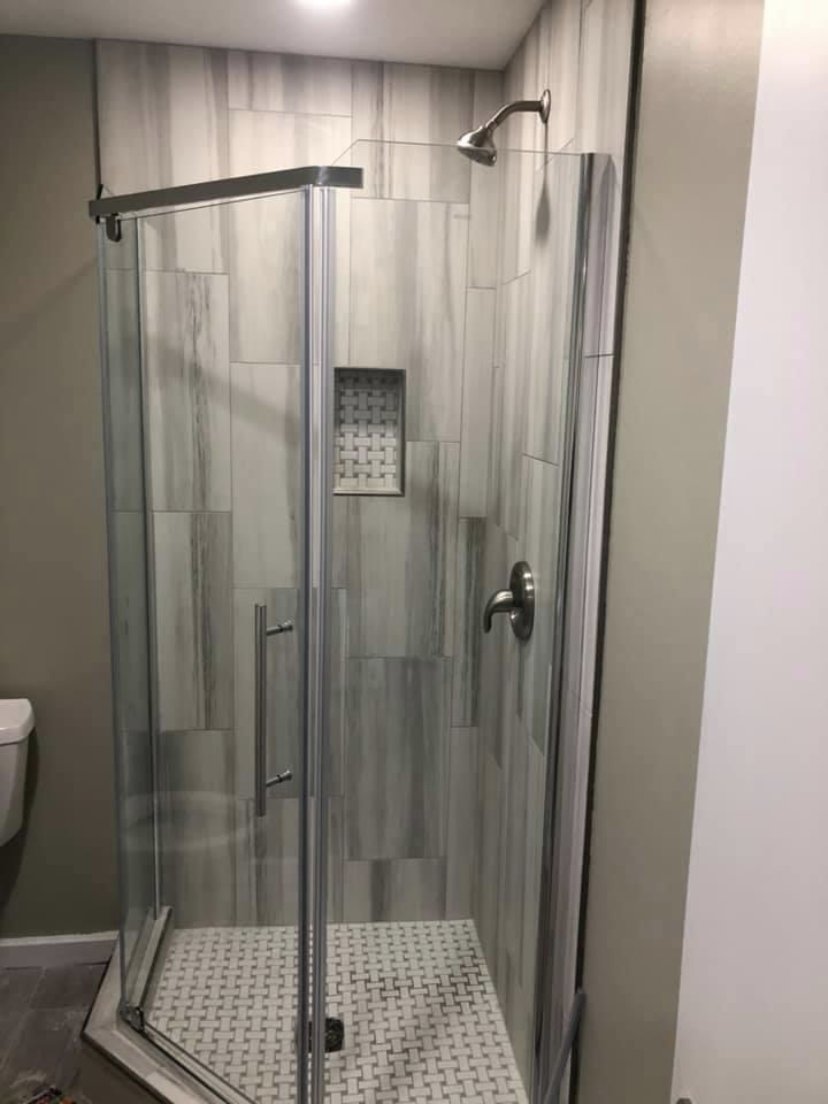Completed shower with glass enclosure and tile work