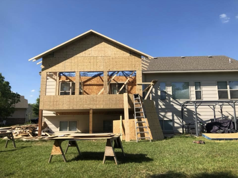 Large house exterior with completed wraparound deck