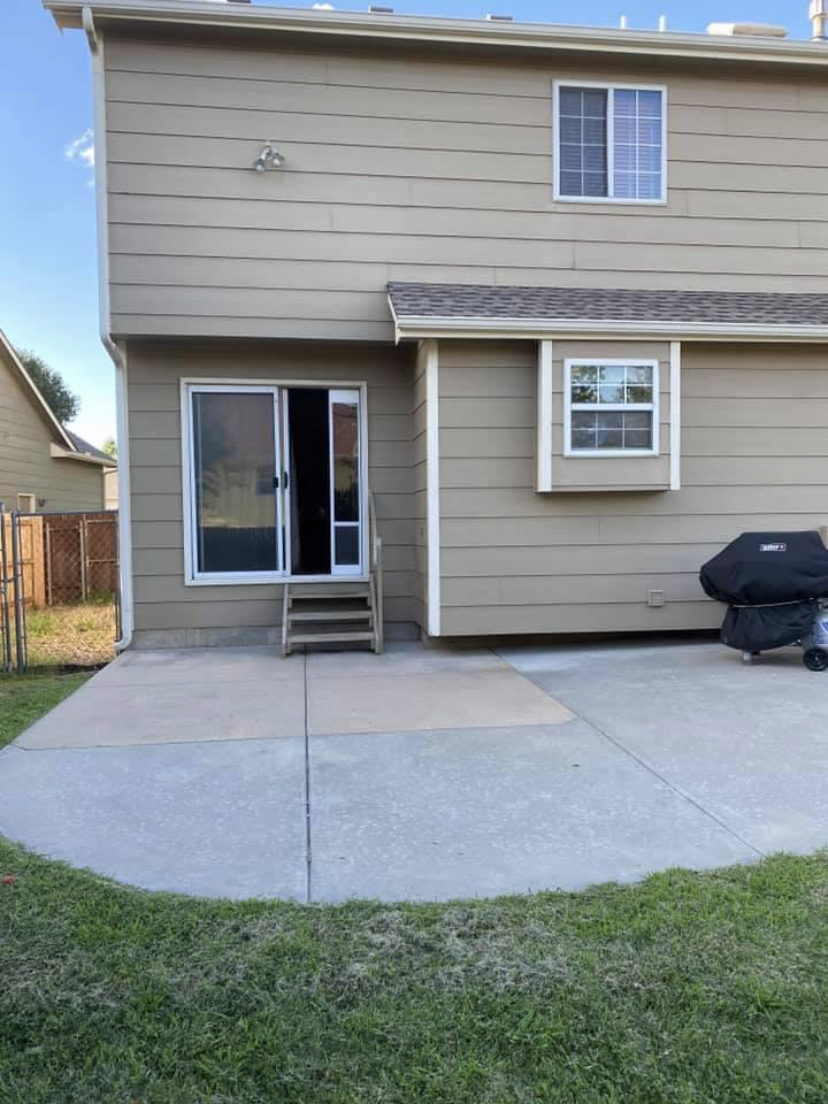 Before — bare concrete patio with no deck
