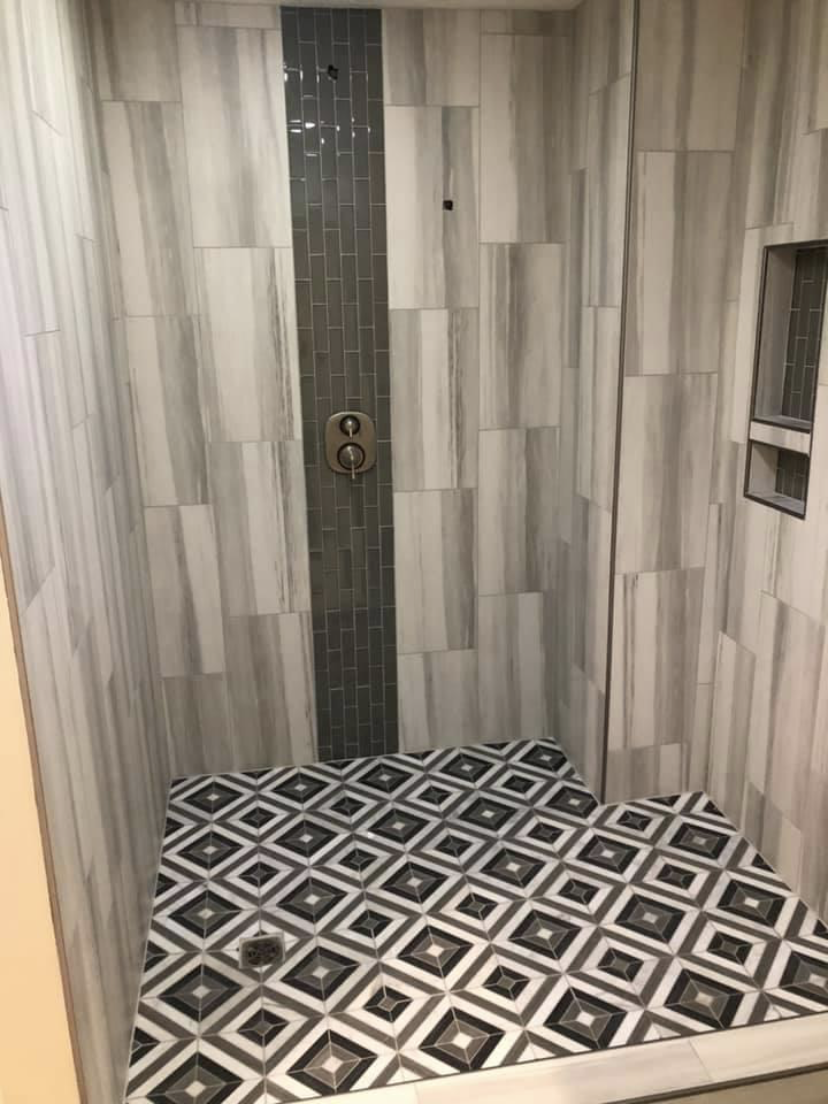Basement shower with decorative tile floor