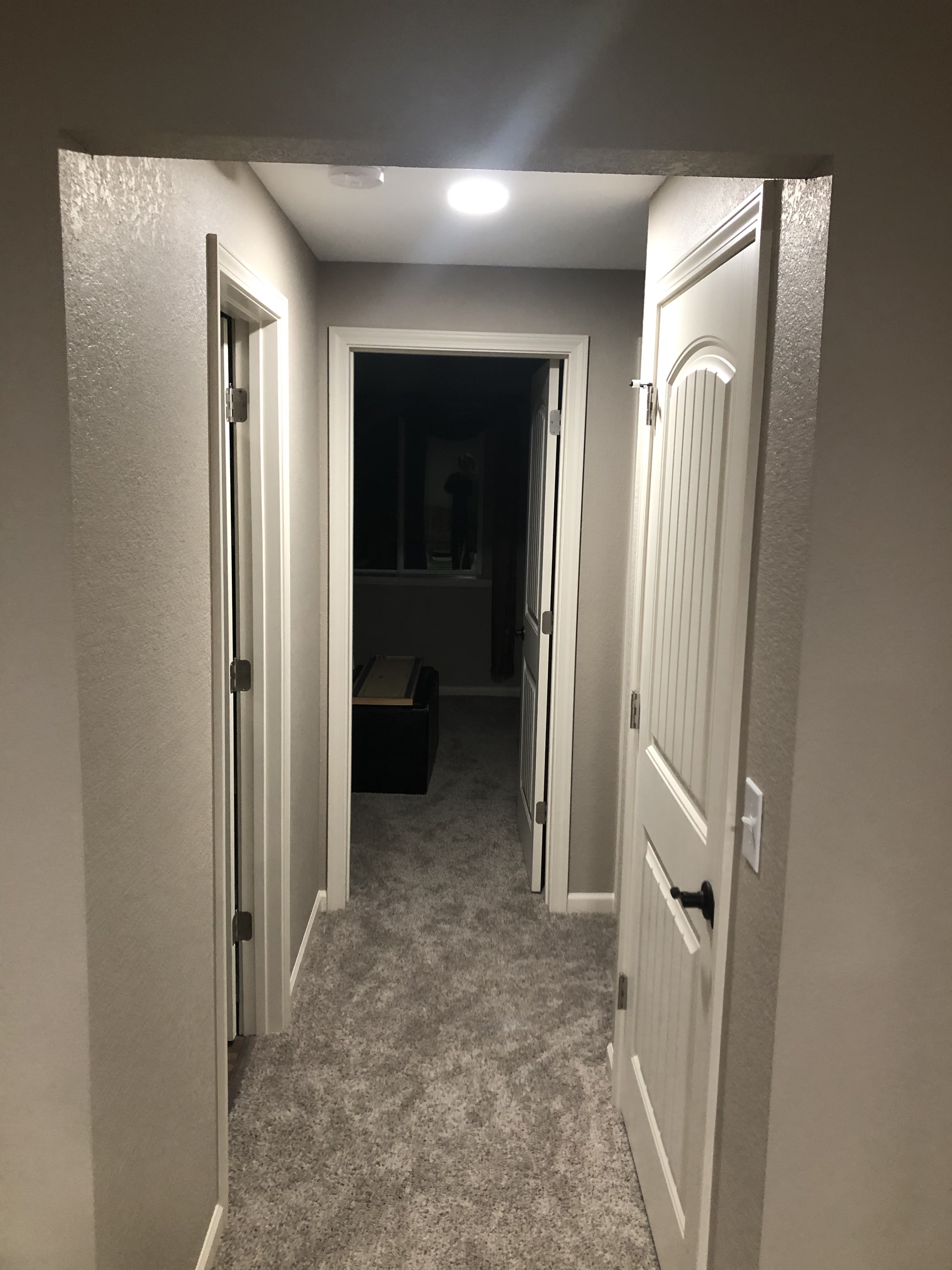 Finished basement hallway with carpet and recessed lighting