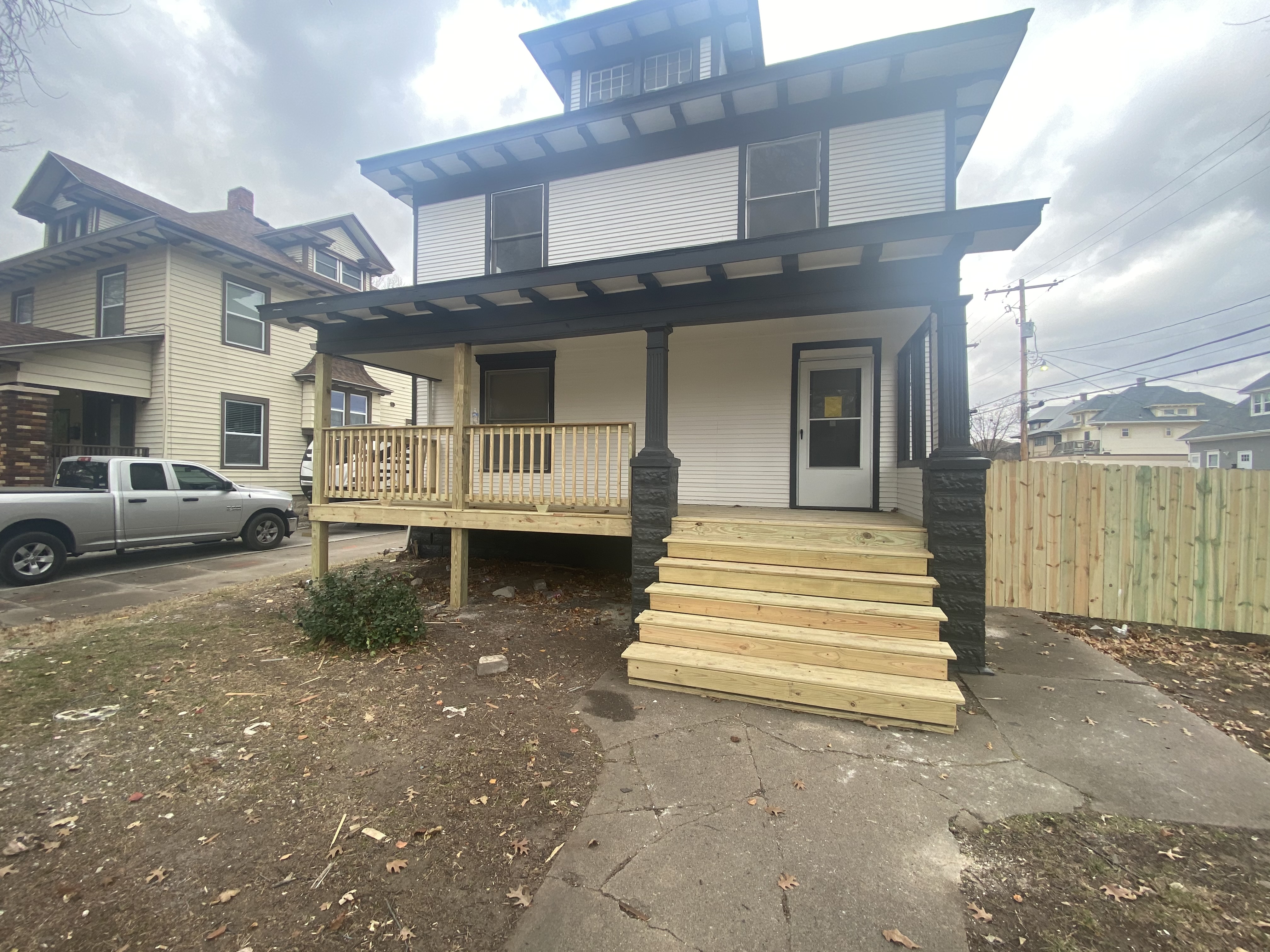 After — fully renovated house with new addition and siding