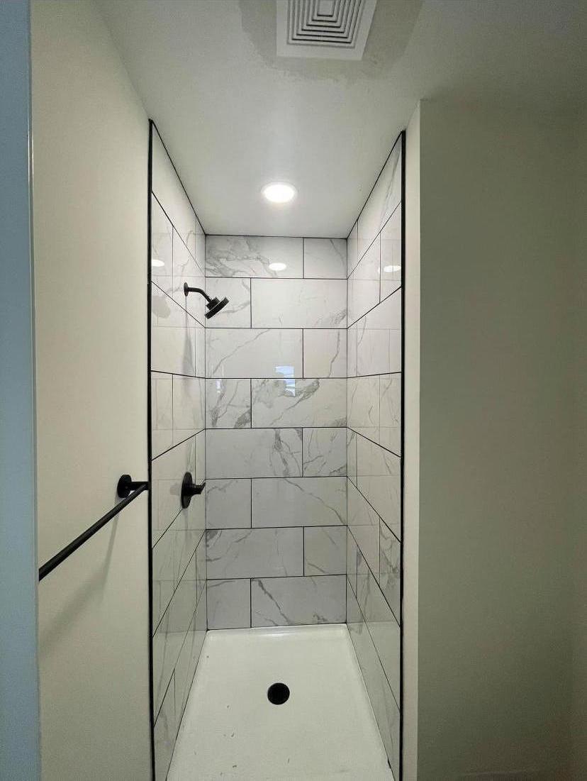 Walk-in shower with marble tile