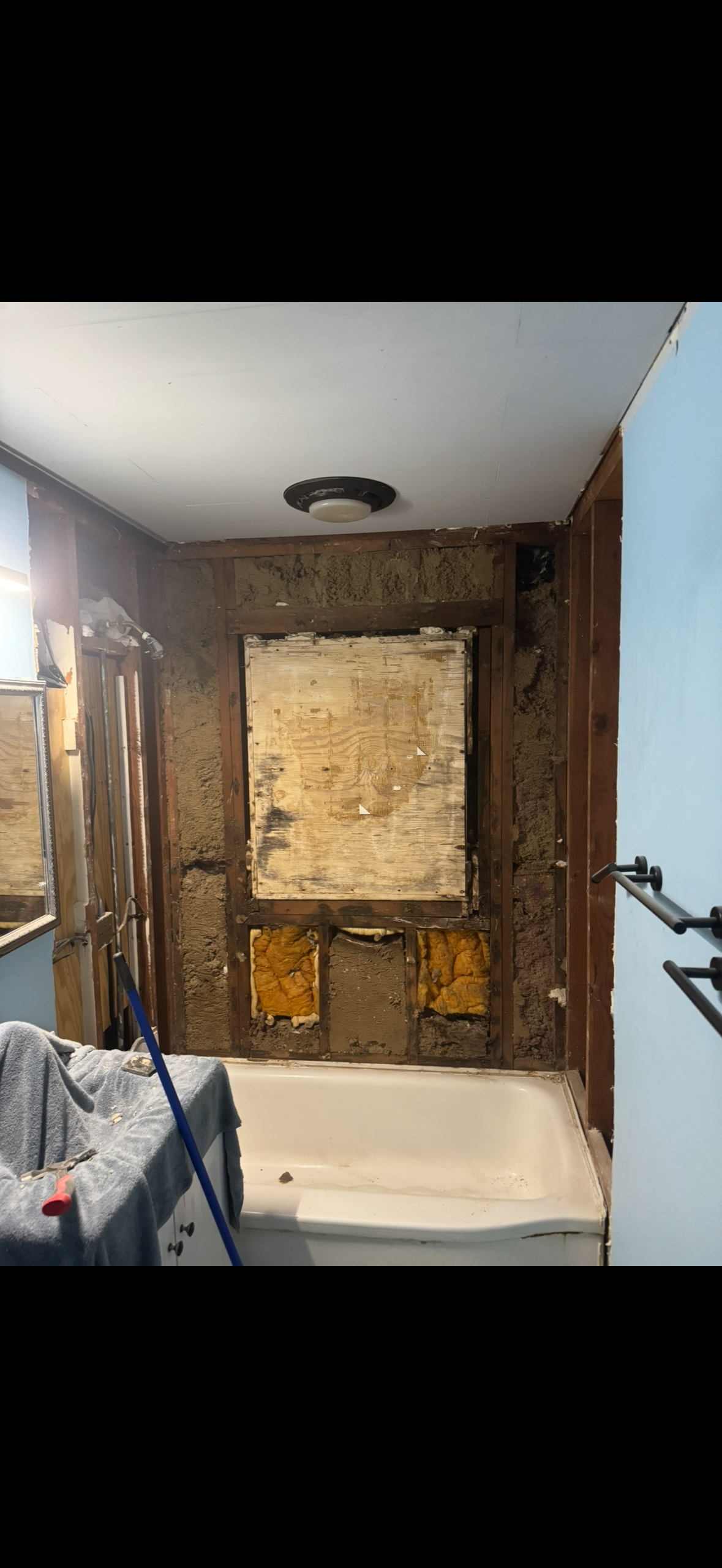 Before — bathroom stripped down, walls opened, full demolition