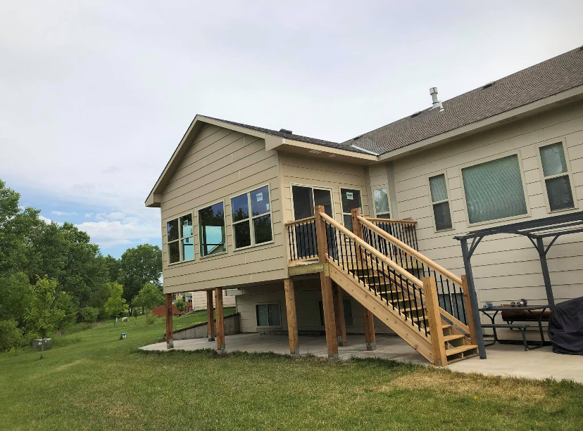 After — completed two-story addition with deck